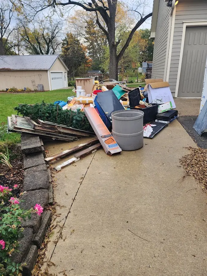 Dumpster being loaded with debris for 3 Yard Dumpster Rental in Pflugerville